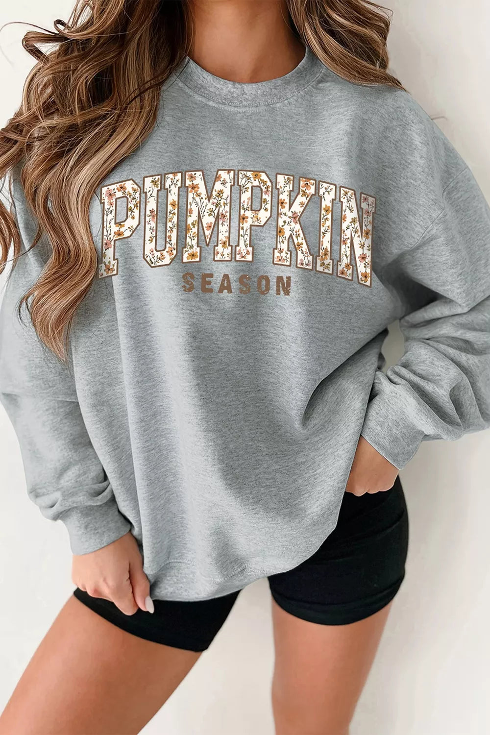Gray oversized pullover sweatshirt with “PUMPKIN SEASON” graphic print on front