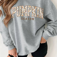 Gray oversized pullover sweatshirt with “PUMPKIN SEASON” graphic print on front