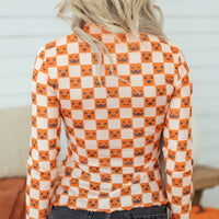 Halloween long sleeve mock neck blouse, back view, orange-and-white check with jack-o’-lantern faces