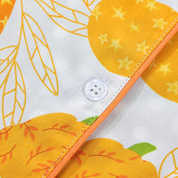Button placket detail with orange piping and pumpkin print on white fabric