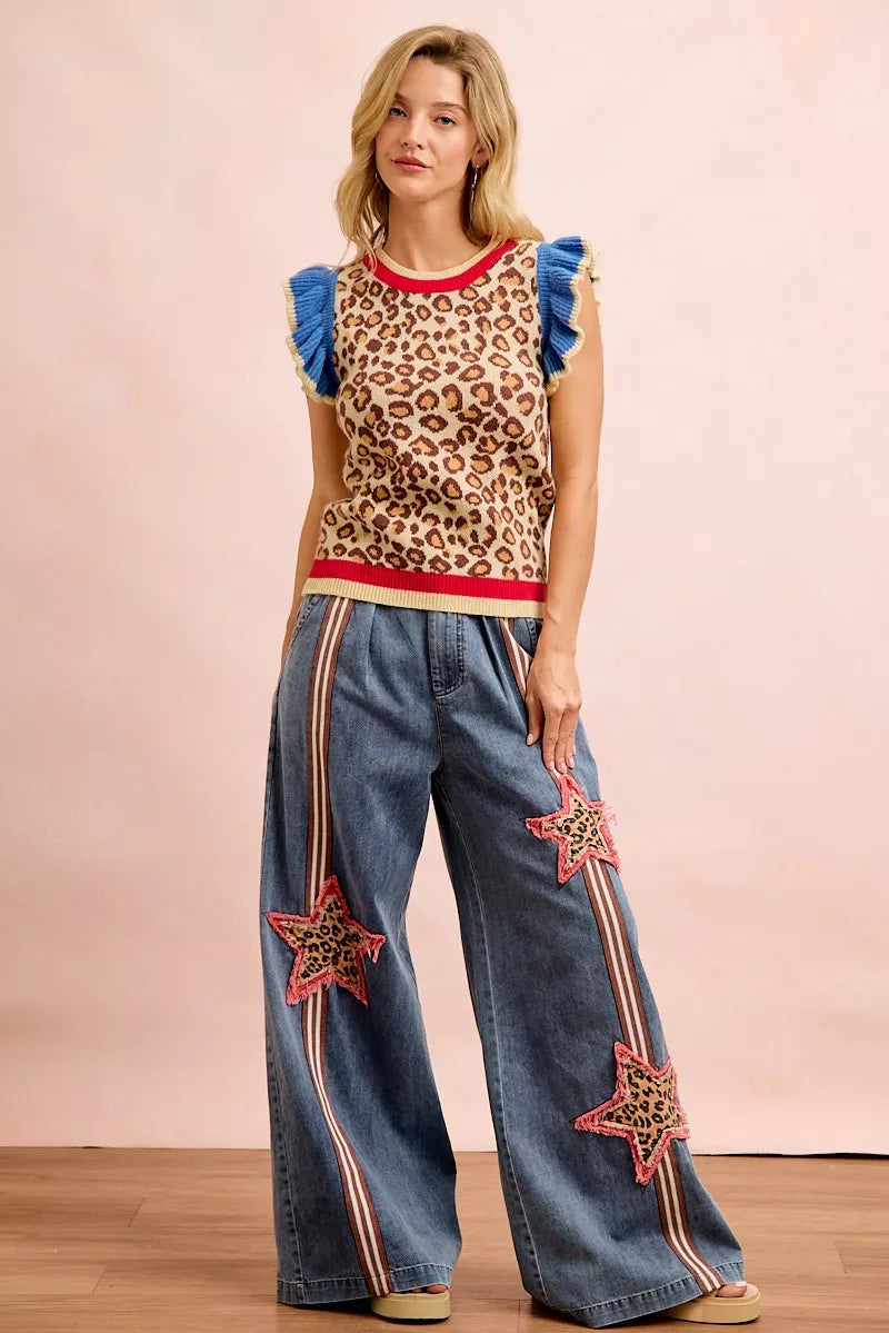 Leopard print knit sleeveless top with blue ruffle shoulder details and red trim