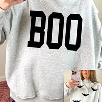 Light gray reversible mock-neck sweatshirt with large black “BOO” front graphic