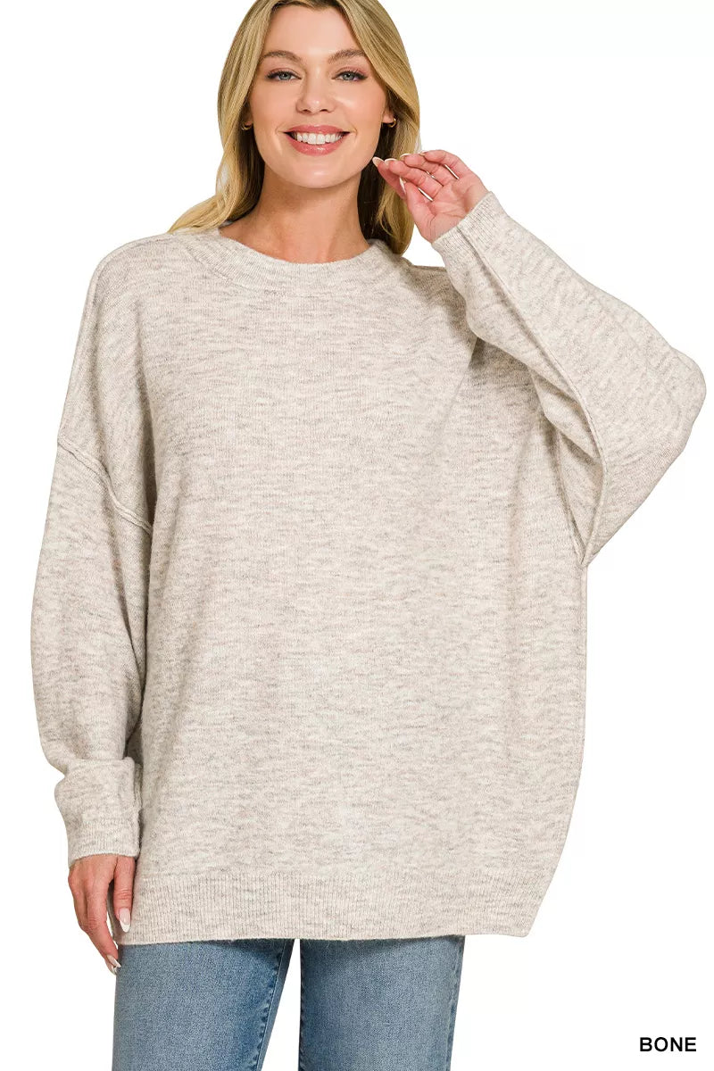 Oversized bone melange sweater with round neck, exposed seams, long sleeves
