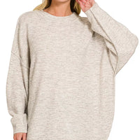 Oversized bone melange sweater with round neck, exposed seams, long sleeves