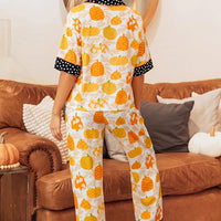 Pumpkin print lounge set with polka-dot cuff trim and button-front top, full-length pants