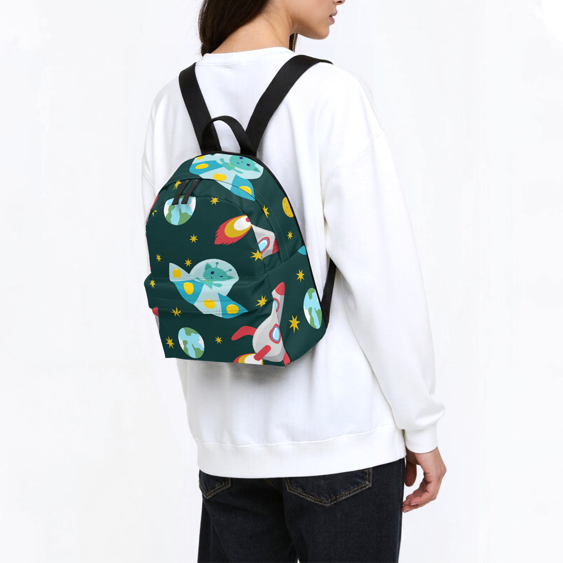 Dark green space-print canvas backpack with black shoulder straps, worn from behind.