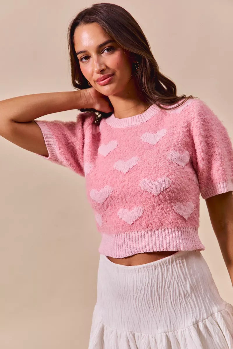 Pink cropped knit sweater with small white hearts, crew neck, short sleeves