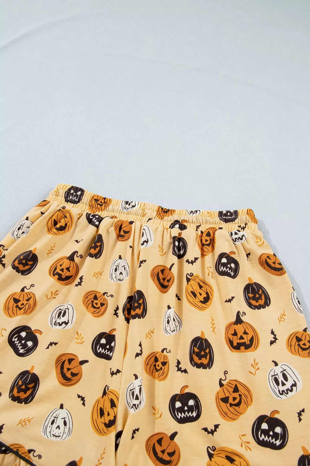 Gold Halloween pumpkin print lounge shorts, elastic waistband and all-over pattern
