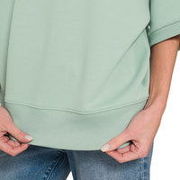Dusty green pullover with curved hem and ribbed cuffs, V-neck front