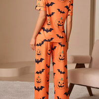 Orange pajama set with back button-up top and long lounge pants, pumpkin and bat print