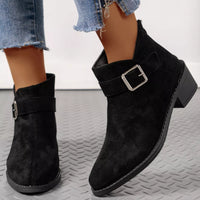 Black suede point-toe block heel ankle boots with front strap and square buckle
