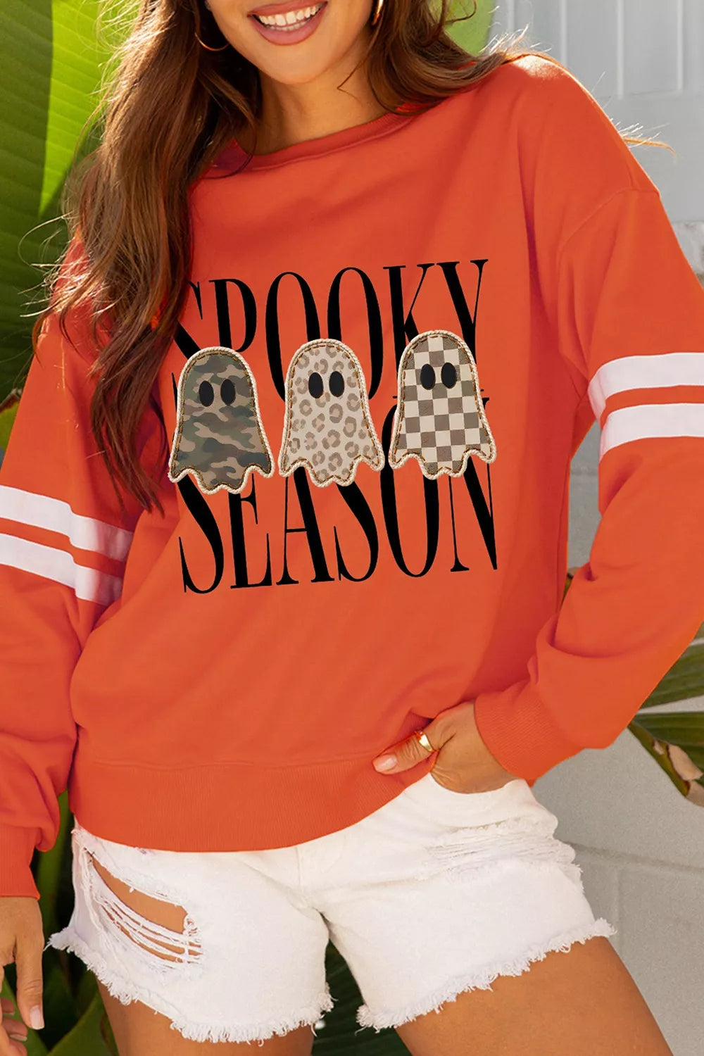 Orange ghost trio pullover sweatshirt with varsity striped sleeve cuffs