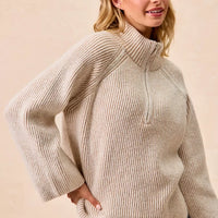 Two-tone rib knit zip-collar top, taupe and cream, angled back view