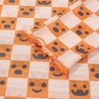 Orange and white mock-neck long-sleeve blouse with jack-o'-lantern face pattern
