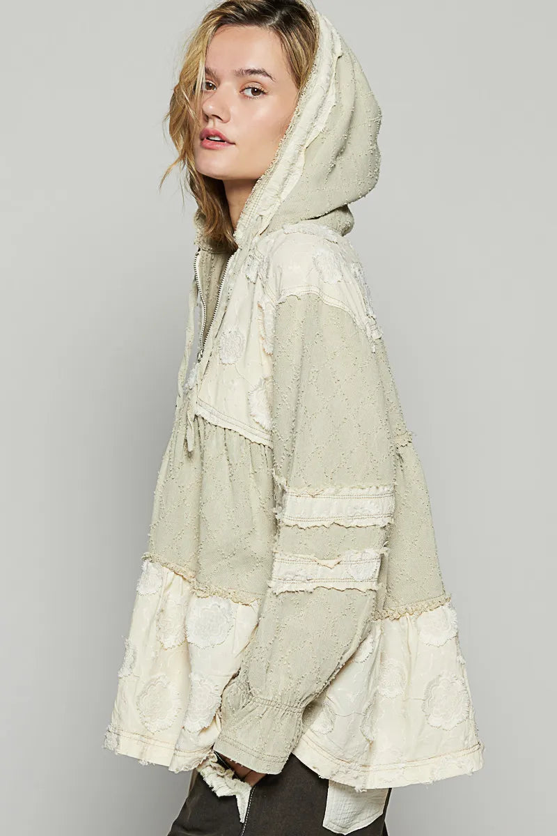 Beige hooded color-block jacket, raw hem and frayed seams visible from side