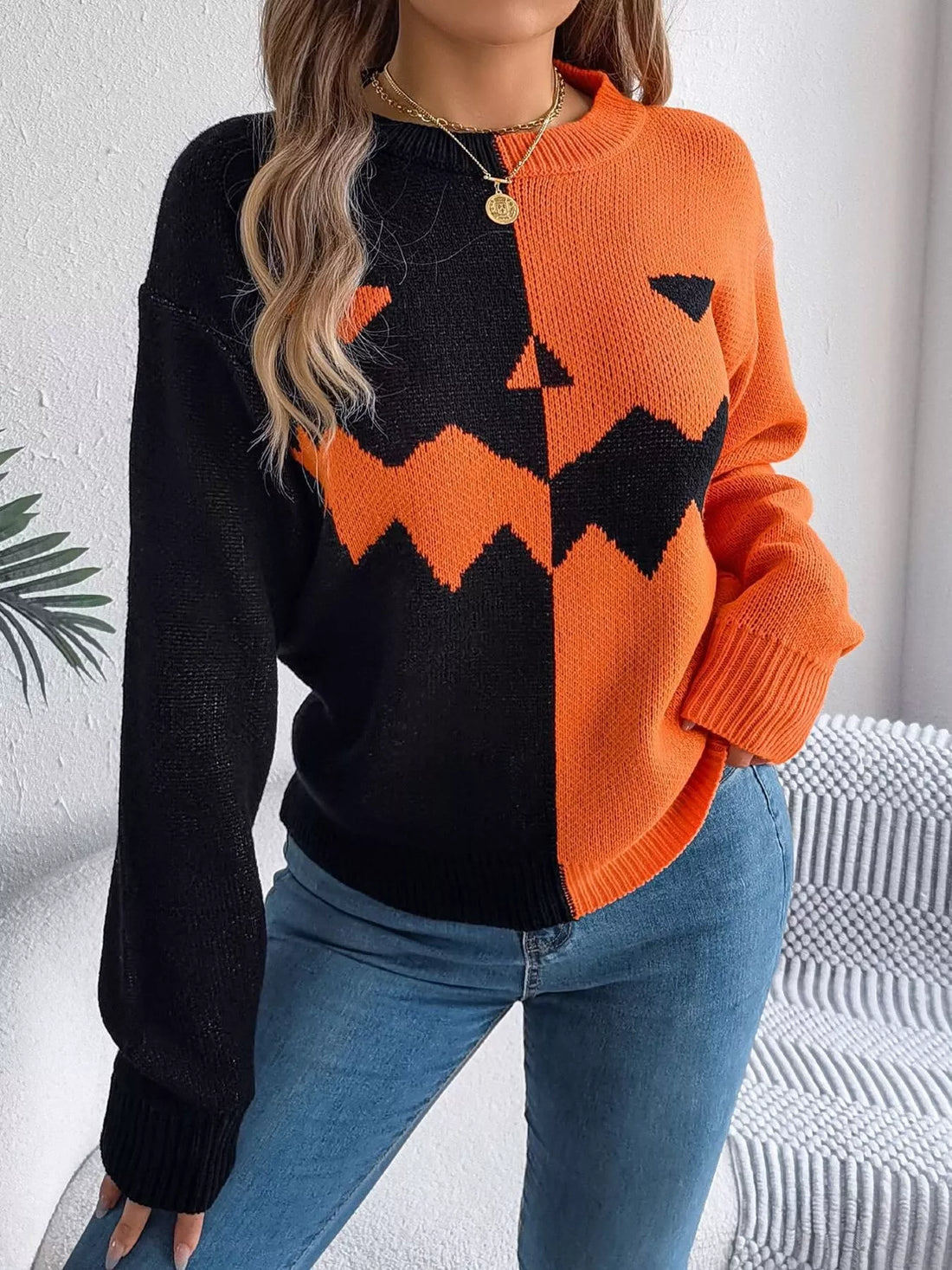 Two-tone pumpkin face graphic sweater, orange/black zip-front knit, long sleeves