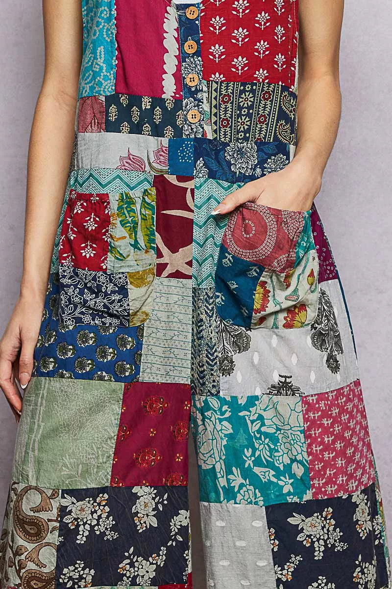 Sleeveless patchwork jumpsuit bodice close-up, multicolor fabric blocks and buttons