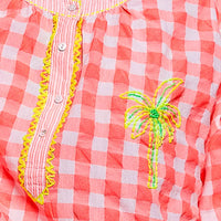 Pink gingham blouse close-up with palm tree embroidery and multicolor trim