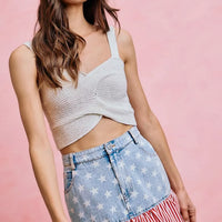 Fit-and-flare denim mini skirt with blue star print and red-white striped ruffle hem