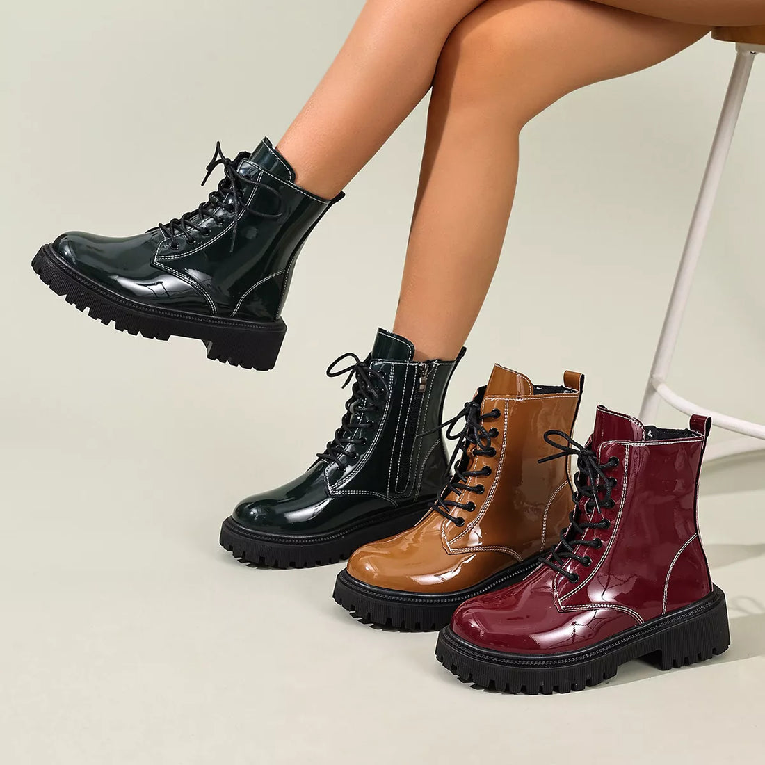Lace-up block heel boots in black, tan, and burgundy patent leather with side zipper