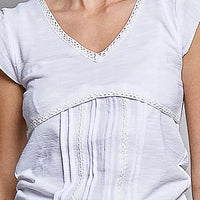 Off-white textured knit V-neck top close-up with lace-trim edge at neckline