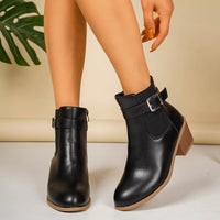 Point-toe block heel boots in black with side zip and buckle ankle strap