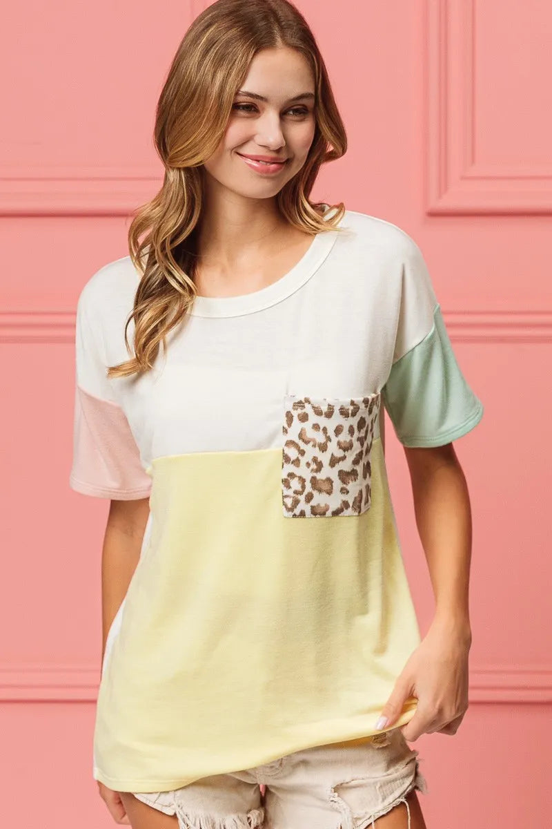 Color block crew neck top with leopard print front pocket and pastel sleeve color blocking