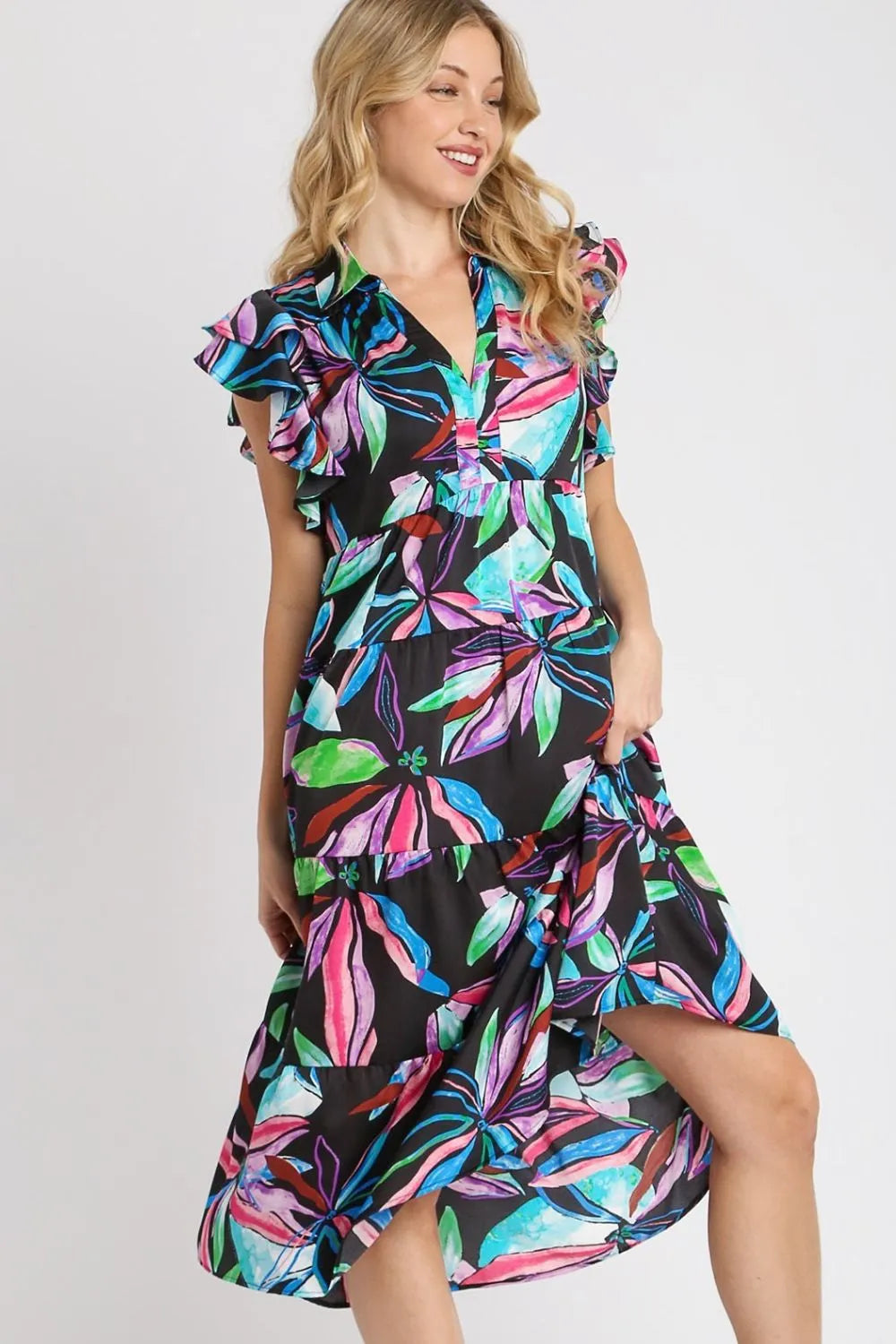 Plus size midi dress side view with ruffle sleeves and tiered hem, dark leaf print.