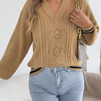 Camel cutout cable knit sweater with front knit floral designs and striped cuffs