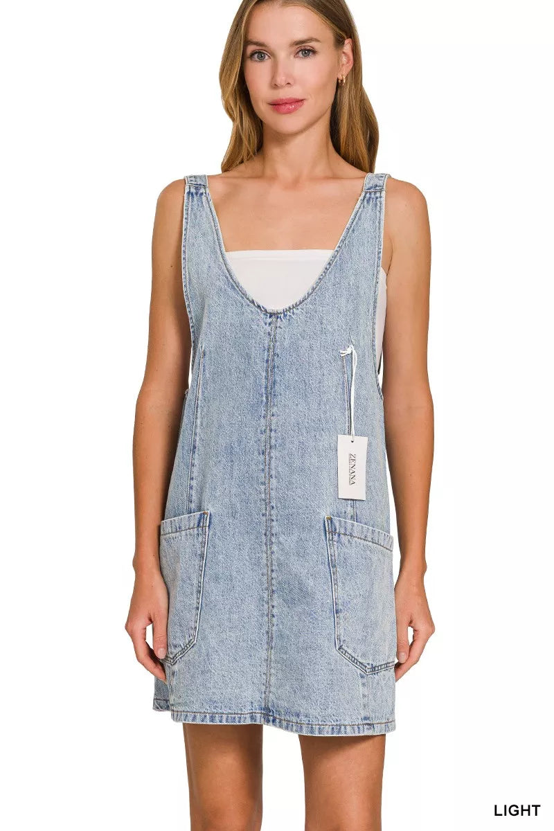 Light wash denim overall dress with square neckline and front pockets