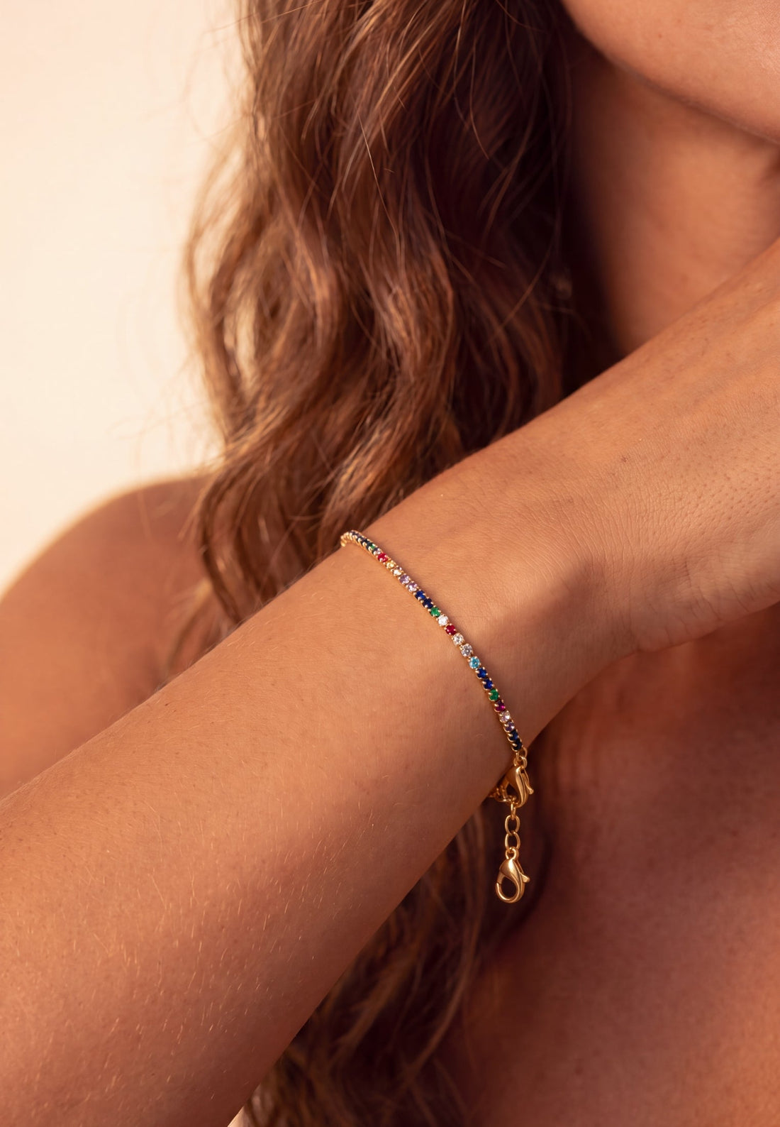 Gold bracelet with rainbow CZ stones and heart charm toggle clasp