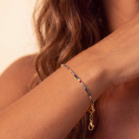Gold bracelet with rainbow CZ stones and heart charm toggle clasp