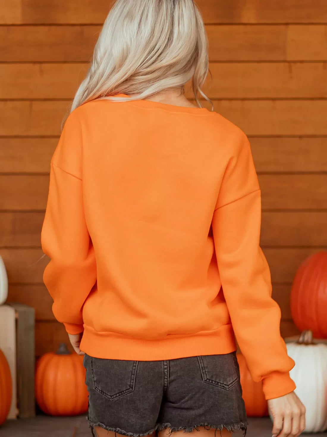 Orange Halloween crewneck sweatshirt back view with ribbed collar and cuffs
