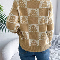 Back view: beige checkerboard knit sweater with jack-o-lantern face pattern, long sleeves