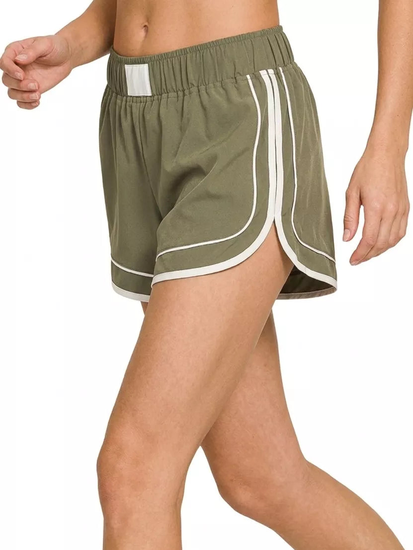Dusty olive soft woven lined dolphin shorts, curved hem with white border