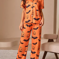 Orange short-sleeve button pajama set with pumpkin and bat print, matching lounge pants