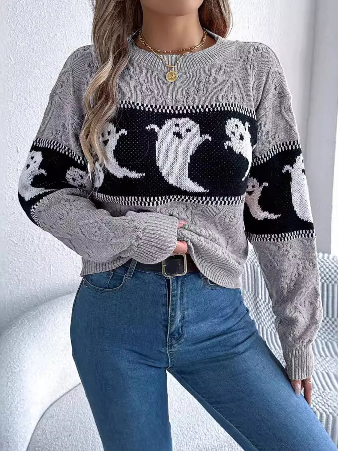 Gray Halloween ghost-pattern sweater with ribbed cuffs and black contrast stripe trim