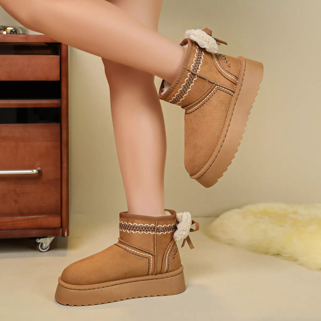 Camel suede platform ankle boots with round toe, shearling cuffs, and lace bow
