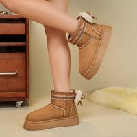Camel suede platform ankle boots with round toe, shearling cuffs, and lace bow
