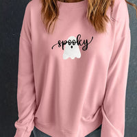Dusty pink round-neck sweatshirt with spooky ghost graphic, long sleeves