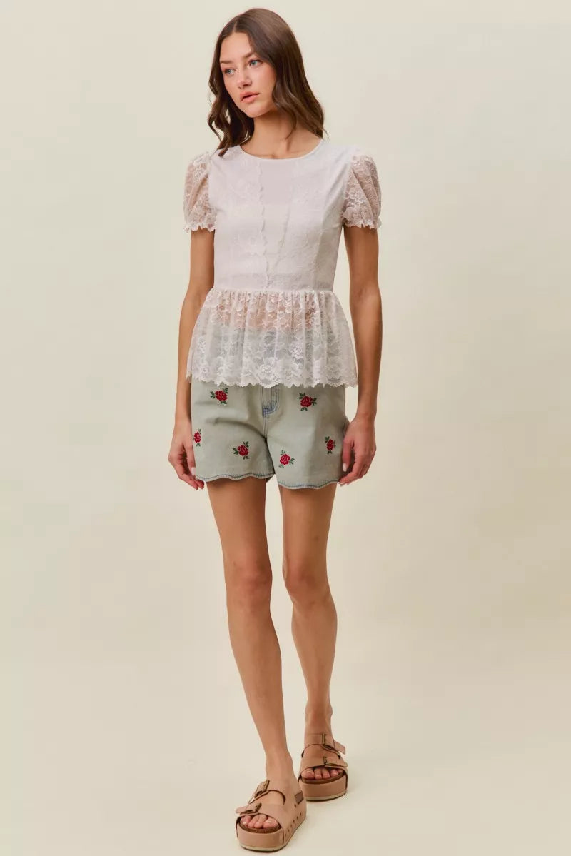 Light-wash denim shorts with rose embroidery, worn with sandals