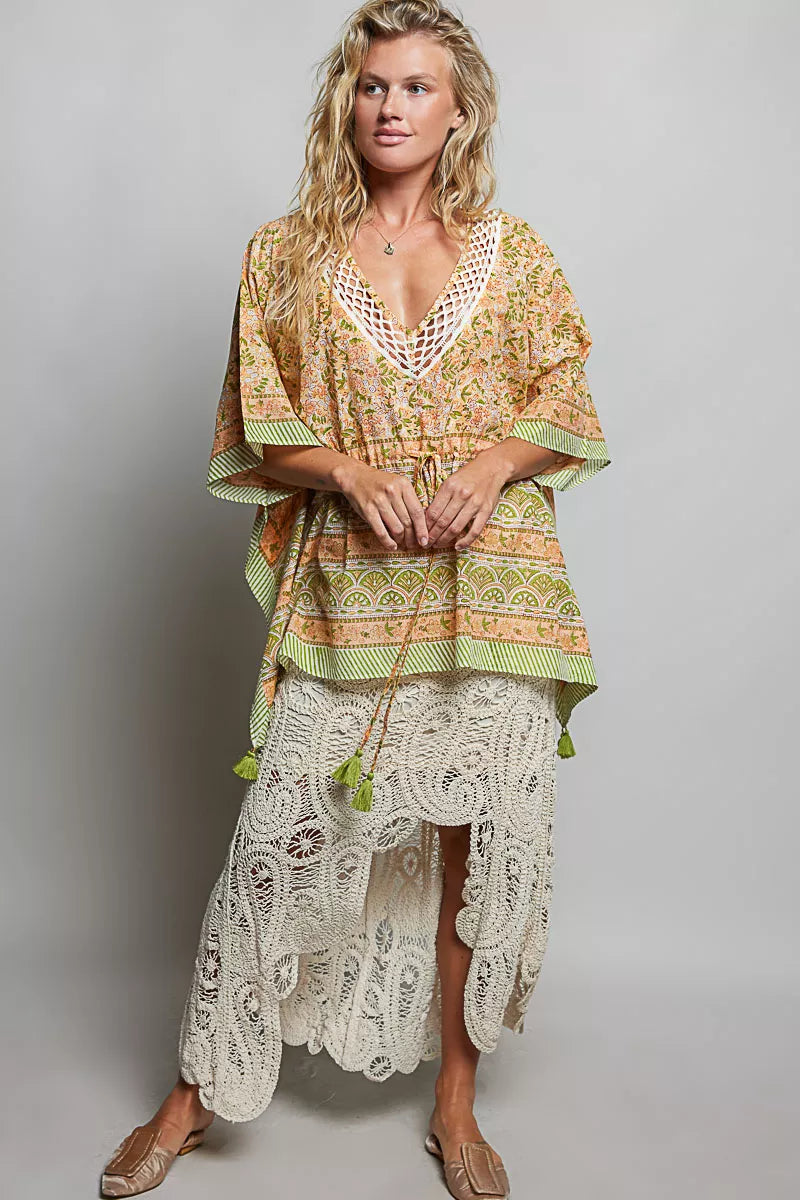 Coral floral tie-front blouse with V-neck and gathered waist, tassel ties at hem