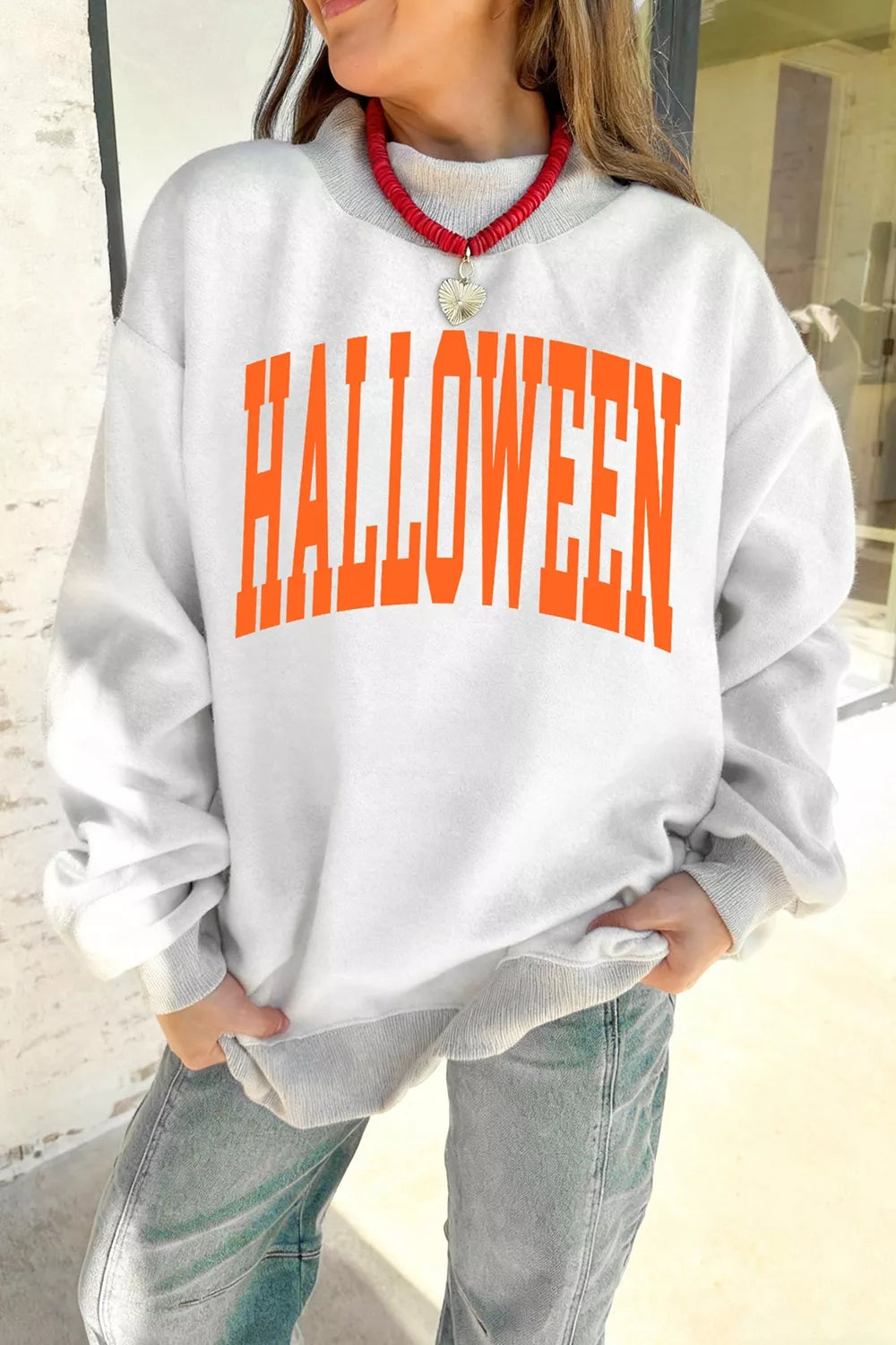 Light gray sweatshirt with large orange “HALLOWEEN” text, mock neck
