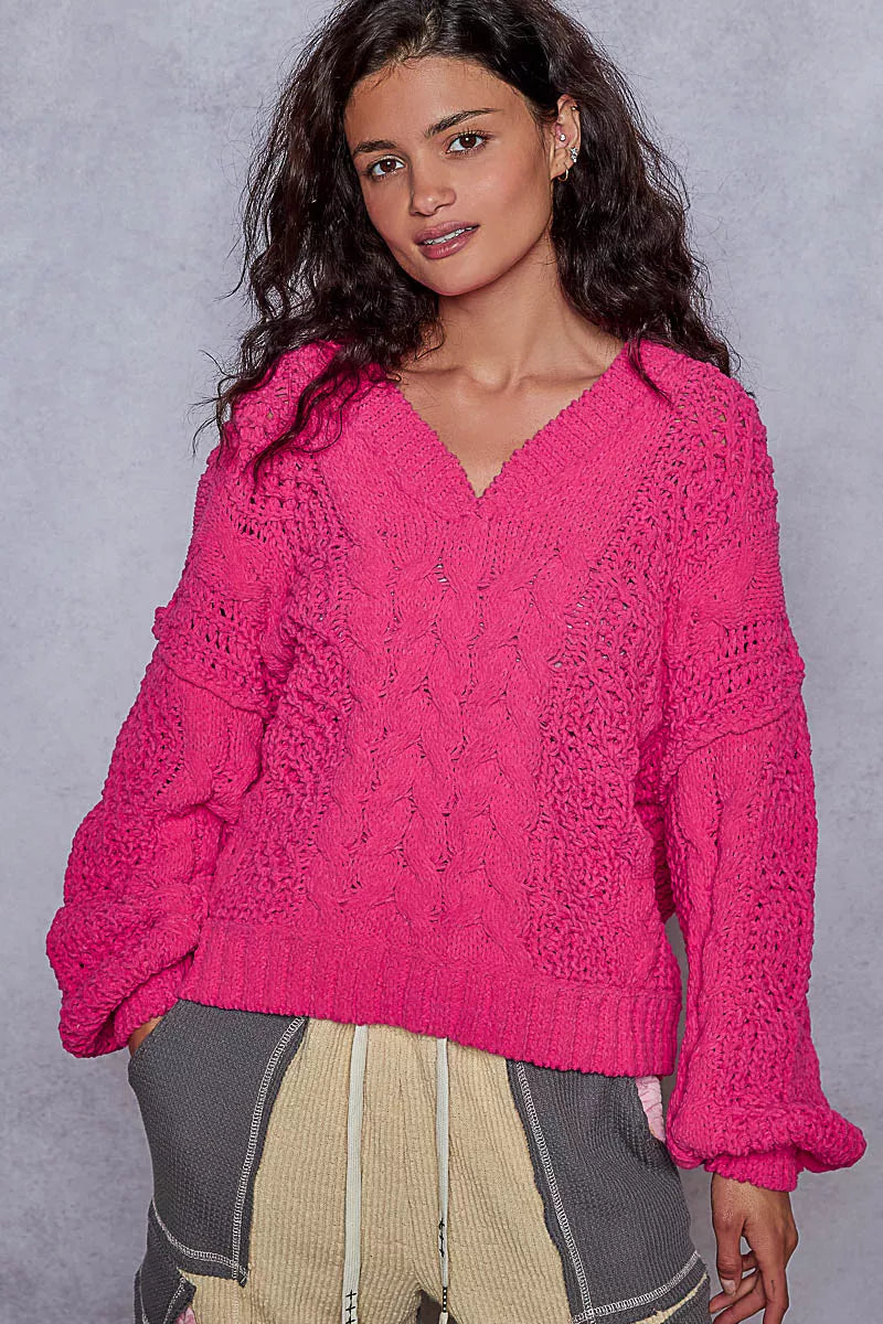 Fuchsia cable-knit cropped V-neck sweater with long sleeves and subtle cable stitch pattern