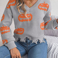 Gray V-neck pumpkin sweater with orange intarsia pattern and frayed, distressed hem