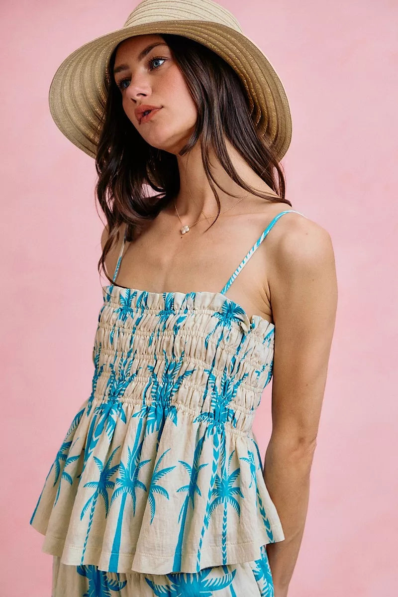 Blue palm-print smocked cami top with adjustable spaghetti straps and tiered peplum