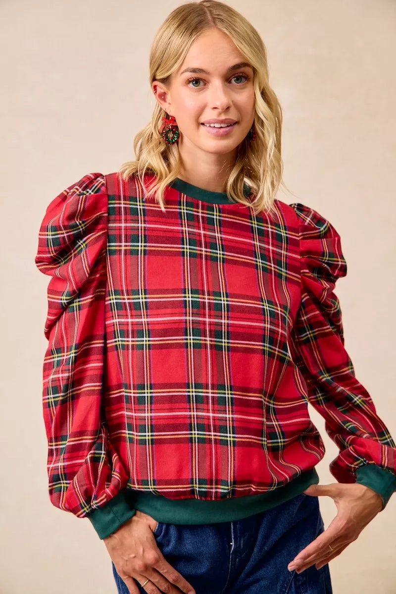 Red plaid top with exaggerated shoulders and balloon sleeves with green ribbed cuffs