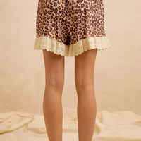 Leopard print drawstring shorts with scalloped eyelet lace trim at hem