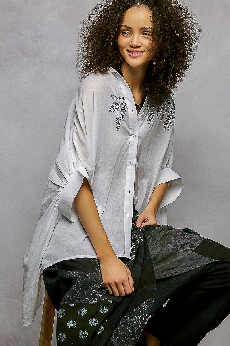 Ivory embroidered floral button-front shirt with draped sleeves and high-low hem
