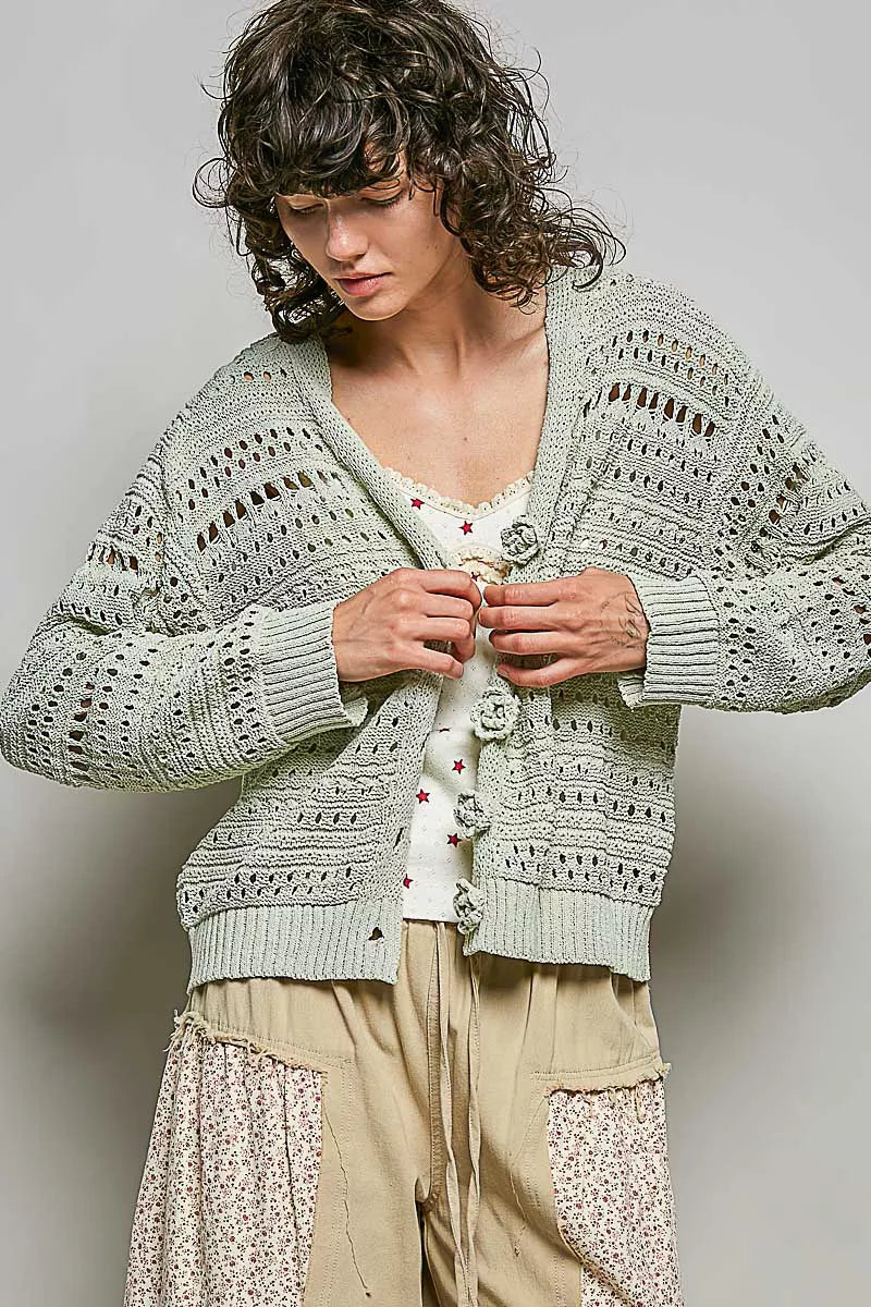 Light gray open-knit cardigan with button front and flower details, long sleeves